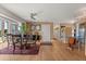 Open-concept dining area with hardwood floors, a round table, and an adjacent modern kitchen at 151 N Orlando Ave # 212, Winter Park, FL 32789