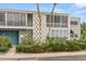 Contemporary condo building showcasing neutral tones, large windows, and mature landscaping at 151 N Orlando Ave # 212, Winter Park, FL 32789