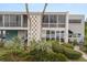 Modern condo featuring a unique facade with lush landscaping, a blue door and decorative concrete block at 151 N Orlando Ave # 212, Winter Park, FL 32789