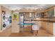 Modern kitchen with stainless steel appliances, custom cabinets, and an island with a blue countertop at 151 N Orlando Ave # 212, Winter Park, FL 32789