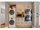 Laundry area with a stacked washer/dryer and built-in oven/microwave at 151 N Orlando Ave # 212, Winter Park, FL 32789