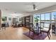 Bright living room with hardwood floors, water view, and a ceiling fan at 151 N Orlando Ave # 212, Winter Park, FL 32789