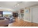 Spacious living area with hardwood floors, built-in shelving, and modern track lighting at 151 N Orlando Ave # 212, Winter Park, FL 32789