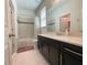A well-lit bathroom features an extended vanity and a shower-tub combo at 16611 Toccoa Row, Winter Garden, FL 34787