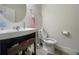 Bathroom featuring a toilet, sink with dark vanity, mirror, and towel rack at 16611 Toccoa Row, Winter Garden, FL 34787