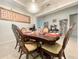 Stately dining room with decorative chandelier, large table with ornate chairs, and wine rack at 16611 Toccoa Row, Winter Garden, FL 34787