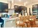 Modern kitchen with stainless steel appliances, granite countertops, and counter seating at 16611 Toccoa Row, Winter Garden, FL 34787