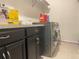 A laundry room offers a washing machine, dryer, and dark cabinets at 16611 Toccoa Row, Winter Garden, FL 34787