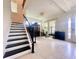 Inviting living room with staircase featuring black railing, tile flooring, grand piano, and lots of light at 16611 Toccoa Row, Winter Garden, FL 34787
