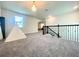 This is an open loft area featuring carpet and a decorative chandelier at 16611 Toccoa Row, Winter Garden, FL 34787