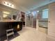 A main bathroom featuring white tile flooring, a tub, and a walk-in closet at 16611 Toccoa Row, Winter Garden, FL 34787