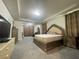 A spacious main bedroom features gray carpet and a decorative headboard on the bed at 16611 Toccoa Row, Winter Garden, FL 34787