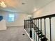 Second-floor hallway with modern railing, carpeted floors, and natural light, creating an inviting space at 16611 Toccoa Row, Winter Garden, FL 34787