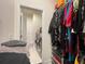 Walk-in closet leading to laundry room with ample hanging space and built-in storage, enhancing convenience at 16611 Toccoa Row, Winter Garden, FL 34787