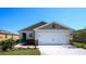 Charming single-Gathering home with manicured lawn, neutral colors, and a spacious two-car garage at 1678 Badger Creek Rd, Kissimmee, FL 34744