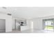 Open-concept living area boasts grey cabinets, a kitchen island and sliding glass doors to the backyard at 176 Duckweed Ave, Fruitland Park, FL 34731