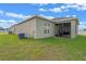 Backyard featuring a lush green lawn and an exterior patio with screens and neutral siding at 189 Luxmore Rd, Groveland, FL 34736