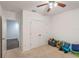 Bedroom with carpet, ceiling fan and an open door, showing the layout and storage options at 189 Luxmore Rd, Groveland, FL 34736