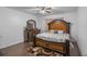 Bedroom features an ornate wood bed frame and matching dark wood dresser with decorative accents at 189 Luxmore Rd, Groveland, FL 34736