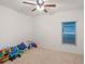 Bright and airy bedroom with a ceiling fan, toys, and a window offering plenty of natural light at 189 Luxmore Rd, Groveland, FL 34736