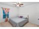 Cozy bedroom featuring a ceiling fan and a plush bed with a patterned comforter and pillows at 189 Luxmore Rd, Groveland, FL 34736