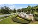 Entrance to Preserve at Sunrise, showcases lush landscaping and decorative signage among palm trees at 189 Luxmore Rd, Groveland, FL 34736
