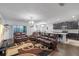 Open concept living space with hardwood floors and modern furnishings flowing into a kitchen with dark wood cabinets at 189 Luxmore Rd, Groveland, FL 34736