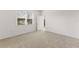 Cozy bedroom with plush carpeting, natural light from a window, and a white paneled door at 192 Duckweed Ave, Fruitland Park, FL 34731