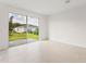 Bright living room with ceramic tile floors and sliding glass doors leading to a backyard at 192 Duckweed Ave, Fruitland Park, FL 34731