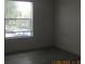Bedroom with window, neutral walls, and wood-style flooring at 2002 Cascades Blvd # 201, Kissimmee, FL 34741