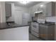 A kitchen has gray cabinets, dark countertops, and appliances at 2002 Cascades Blvd # 201, Kissimmee, FL 34741