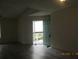 A living room features hard floors and a view to the outside patio at 2002 Cascades Blvd # 201, Kissimmee, FL 34741