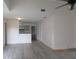 Open living space featuring sleek flooring and a partial view of the kitchen at 2002 Cascades Blvd # 201, Kissimmee, FL 34741