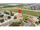 Bird's-eye view of homes with fenced yards, showcasing the neighborhood layout and proximity to roads at 204 Cotswold Cir, Davenport, FL 33837