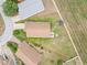 Aerial view of property with large yard, showcasing its layout and landscaping within the neighborhood at 204 Cotswold Cir, Davenport, FL 33837