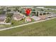 Overhead view of the property and surrounding area, showing the backyard, fence line, and neighboring homes at 204 Cotswold Cir, Davenport, FL 33837