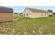 Home exterior with a backyard featuring a shed, patio area, and well-maintained lawn at 204 Cotswold Cir, Davenport, FL 33837