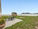 Backyard featuring a patio set, shed, and a spacious lawn for outdoor activities at 204 Cotswold Cir, Davenport, FL 33837
