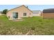 Exterior view of home backyard with a concrete patio, dining set and shed at 204 Cotswold Cir, Davenport, FL 33837