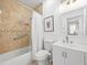 Clean bathroom featuring a tub, shower, vanity, toilet, and decorative accents at 204 Cotswold Cir, Davenport, FL 33837