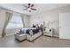 Charming bedroom with stylish floral bedding, soft lighting, and a comfortable bench at 204 Cotswold Cir, Davenport, FL 33837