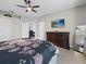 Bright bedroom featuring TV, large dresser and a mirror at 204 Cotswold Cir, Davenport, FL 33837