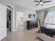 Bright bedroom featuring a TV, a dresser, and access to a closet and bathroom at 204 Cotswold Cir, Davenport, FL 33837