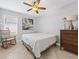 Inviting bedroom with soft natural light, rocking chair, and dresser at 204 Cotswold Cir, Davenport, FL 33837
