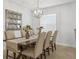 Elegant dining room with a modern chandelier and comfortable seating for formal occasions at 204 Cotswold Cir, Davenport, FL 33837