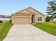 Charming single-story home featuring a two-car garage, well-manicured lawn and inviting curb appeal at 204 Cotswold Cir, Davenport, FL 33837