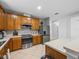 Efficient kitchen featuring modern appliances, warm wood cabinets, and plenty of storage at 204 Cotswold Cir, Davenport, FL 33837
