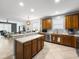 Open-concept kitchen with a center island, stainless steel appliances, and seamless flow to the living area at 204 Cotswold Cir, Davenport, FL 33837