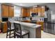 Well-equipped kitchen with stainless steel appliances, breakfast bar, and ample cabinet space at 204 Cotswold Cir, Davenport, FL 33837