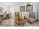 Relaxing living room showcasing stylish chairs and a coffee table, adjacent to the dining area at 204 Cotswold Cir, Davenport, FL 33837